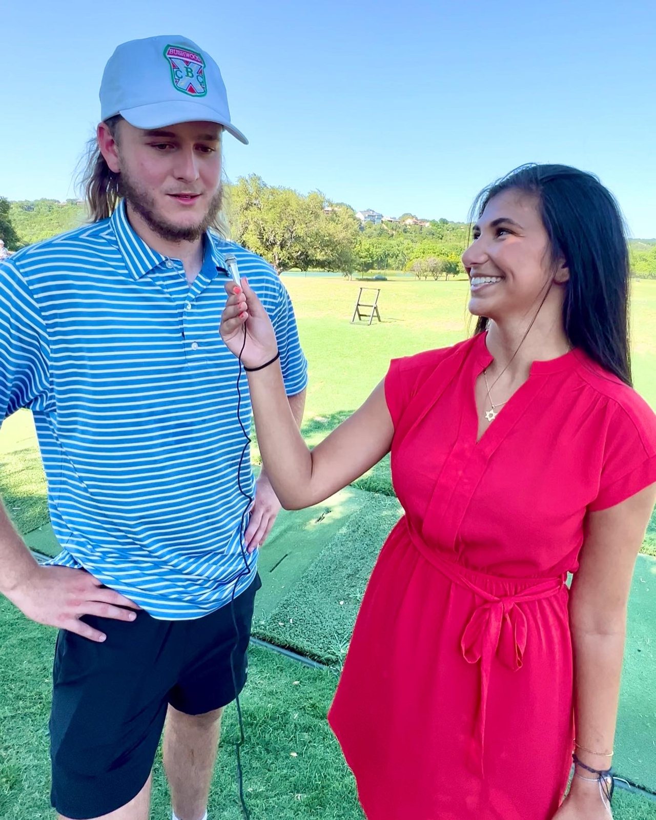 Reilly interviewing quarterback Quinn Ewers on a golf course
